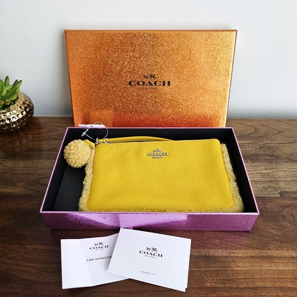 Coach Handbags - Vintage NWT Coach Shearling Small Wristlet in Banana Yellow With Pom Pom